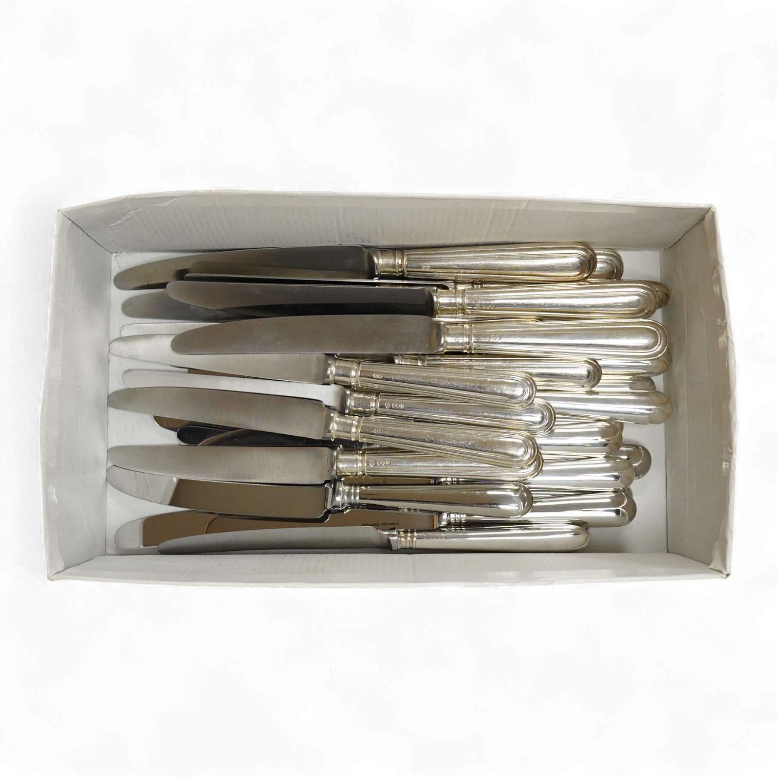 A modern set of six silver handled steel table knives and six dessert knives, maker DJS, Sheffield, 1973, together with a set of six silver plate handled steel table knives and six dessert knives.